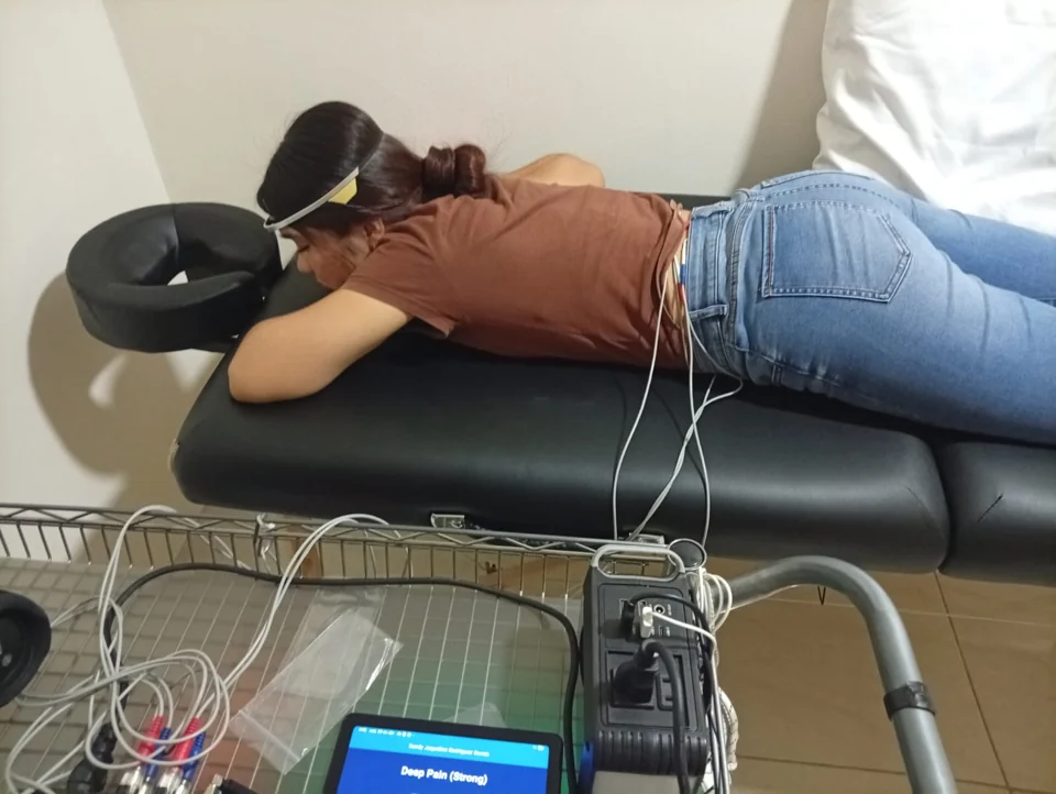 Research-room photograph of a session with an EEG headband and connected equipment
